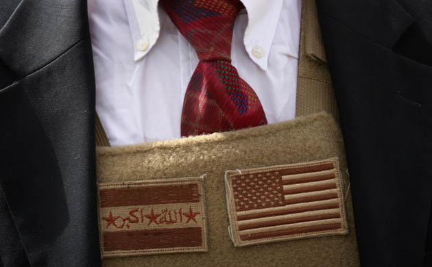 Ramadi, Iraq: Iraqi and American flags decorate the body armour of US ambassador Ryan Crocker