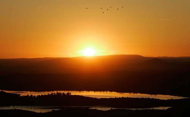 Reguengos, Portugal: The sun rises over the lake of the Alqueva dam