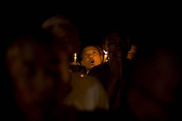 Katmandu, Nepal: A Tibetan exile monk holds a torch during a prayer session for those killed during the Chinese government's crackdown in Tibet