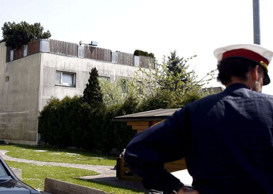 A policeman outside the Fritzl family home in Amstetten