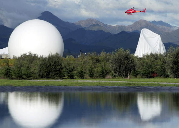 The damaged inflatable cover, right, is seen on the satellite dish at Waihopai Spy Base, after activists deflated the dome in Blenheim, New Zealand