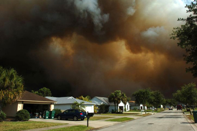 Smoke billows behind homes on Long Leaf Road