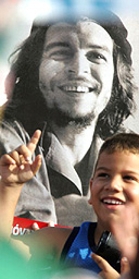 A young boy at May 1 celebrations in Havana stands in front of a poster of the revolutionary Ernesto 'Che' Guevara