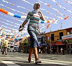 A woman walks along a street festooned with flags in support of the ruling AKP party