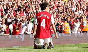 Cesc Fabregas of Arsenal celebrates after scoring the winning goal during the Barclays Premier League match between Arsenal and Manchester City at the Emirates Stadium on August 25