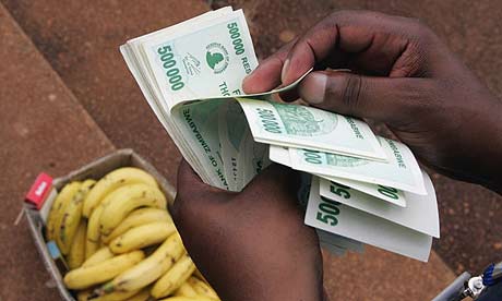 A man counts a big stack of money to buy some bananas in Harare, Zimbabwe