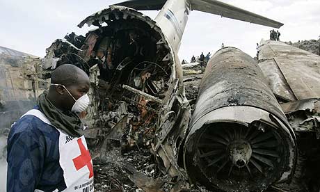 A Red Cross worker walks in the wreckage of the plane crash in Goma, Democratic of Congo