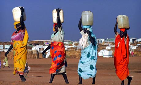 Women carry water in Darfur.