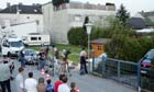 People watch at the back of a house where a 73-year-old man allegedly locked up his daughter in a basement for 24 years and fathered seven children with her, in Amstetten, Austria