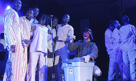 Artists perform a scene showing a satirical version of recent elections in Zimbabwe during the main act of the opening day of the Harare International Festival of the Arts.