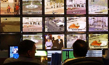 Police officers monitor CCTV screens in the control room at New Scotland Yard in London