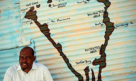 Olivier Bancoult in front of a map of Diego Garcia
