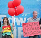 Labour supporters dressed as 'Tory Toffs' stand outside the office of Conservative candidate Edward Timpson in Crewe, Cheshire
