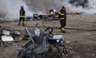 Firefighters inspect the remains of a Gypsy camp set alight in Naples