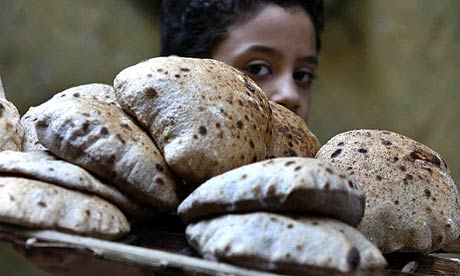 A child carries a tray of bread in Cairo