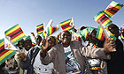 Supporters greet President Robert Mugabe upon his arrival at Harare airport.