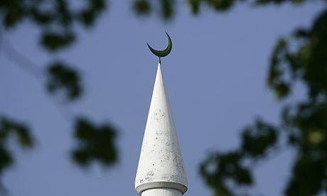 The minaret of the Mahmud mosque is pictured close to a Christian church in Zurich, Switzerland