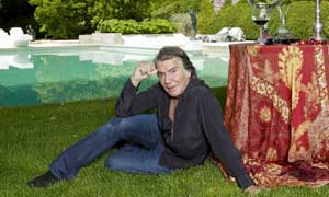 Fashion designer Roberto Cavalli by the pool of his house in Tuscany
