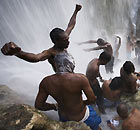 Voodoo and Catholic followers bathe in the waterfall at Saut Deau Haiti