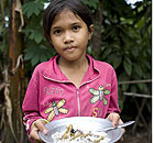 Child with rice in Cambodia