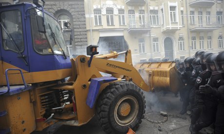 'masked protesters commandeered a mechanical digger and attempted to break through lines of armour-clad riot police' (c) Alexey Furman, EPA, the Guardian, 2nd December 2013
